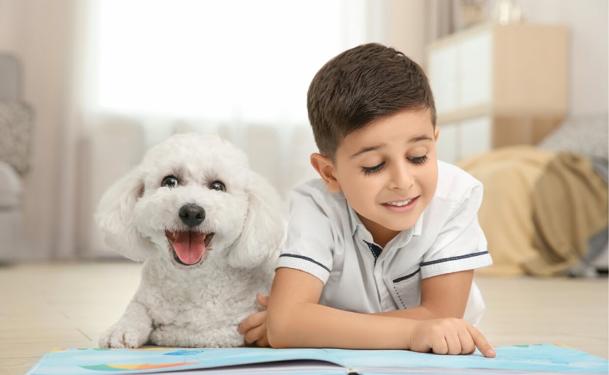 child reading aloud to puppy